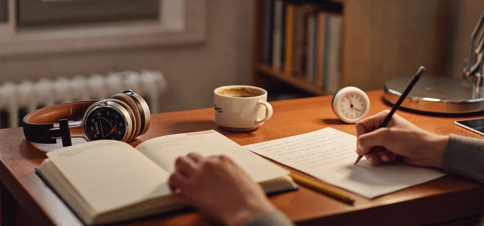 A student preparing for the TEF Canada exam at a desk with headphones and a timer