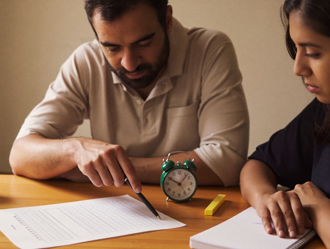 TFA instructor reviewing a TEF Canada mock exam answer sheet with a student
